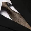 Close-up detail of a classic brown textured tie with subtle blue dots, elegant and stylish. - 8cm Champagne Polka Dot Zipper