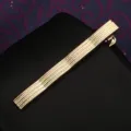 Dettaglio fermacravatta dorato primo piano, elegante design testurizzato per abito da uomo. - Onda d'Acqua Dorata Fermacravatta (Scatola Regalo)