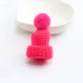 Close-up detail of the mini pink knitted wool hat pendant, showing fine yarn texture and cute pom-pom. - Lotus Red