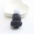 Detailed view of the cute grey knitted hat brooch with white pom-pom, perfect accessory. - Dark Gray
