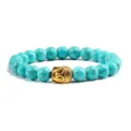 Turquoise steen kralen armband met gouden Boeddha hoofd hanger elastische pols sieraden. - Lichtblauw Turkoois Gouden Legering