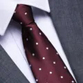 Classic burgundy polka dot men necktie paired with white shirt and grey suit jacket detail. - 8cm Burgundy White Dot Zipper