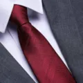 Detailed close-up of a classic red textured men's formal necktie for business and wedding. - 8cm Burgundy Double Stripe Zipper