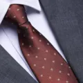 Close-up detail of a red business men's tie featuring elegant geometric square patterns. - 8cm Italian Coffee Zipper