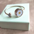 Detailed close-up of rose gold daisy flower open bracelet with cute heart charm piece. - Bangle / Without Repellent Tablet / Lavender