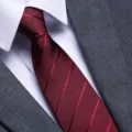 Close-up detail of a mens red striped business tie paired with a crisp white shirt and suit. - Burgundy Twill Zipper