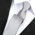 Detailed shot of a stylish grey formal business necktie paired with crisp shirt. - Fine Stripe Zipper / 6 cm Wide / Light Gray
