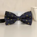 Classic navy blue men's bow tie featuring cute yellow dog and floral patterns for formal wear. - Handsome Pony Bowtie