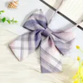 Close-up detail of the purple plaid JK uniform ribbon bow tie, fine fabric texture. - JK027 Orchid Purple Bow Tie