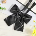 Detail view of black JK plaid bow tie, stylish collar accessory for school shirts. - JK047 Smoke Gray Plaid Bow Tie