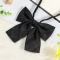Detail shot of black plaid JK bow tie collar accessory, close up view of fabric texture and ribbon. - Versatile Black Plaid Bow Tie