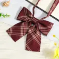 Close-up detail of wine red plaid JK ribbon bow tie, perfect for school uniform styling. - Red Gold Plaid Bow Tie