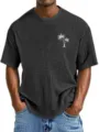 Close-up detail of men's waffle knit short sleeve t-shirt featuring palm tree print. - S / Black