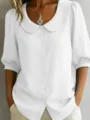 Close-up detail of a white short-sleeve blouse featuring a cute Peter Pan collar and buttons. - S / White