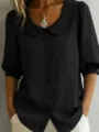 Black short sleeve blouse detail showcasing the elegant Peter Pan collar and button front. - S / Black