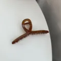 Brown tortoiseshell hair claw clip detail shot, minimalist design for daily hair styling. - Brown