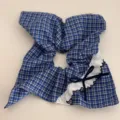 Detailed view of blue plaid hair scrunchie featuring cute lace ruffle and navy bow accent. - Blue Plaid Diagonal Knot Square Ring