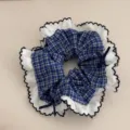 Blue plaid scrunchie detail, white lace ruffle trim, elegant bow hair accessory. - Blue Plaid Petal Edge Scrunchie