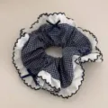 Navy blue plaid hair scrunchie with white lace ruffle trim and cute bows. Detail view for hair. - Fine Plaid Petal Edge Scrunchie
