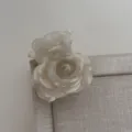 Close-up view of a chic white marble texture rose hair claw clip, elegant floral acrylic accessory. - Mixed White