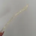 Acetate hair stick detail, minimalist style single hairpin closeup, elegant hair accessory. - Elegant Translucent White