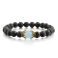 Schwarzes Lavastein Perlenarmband mit blauem Mittelstein und goldenen Kronen Legierung Schmuck. - Aquamarin