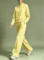 Detailed view of the solid color stand collar cardigan and wide leg casual pants set in yellow. - Yellow