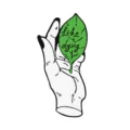 Creative alloy brooch pin featuring a stylized hand holding a green leaf design for decoration. - Tea Leaves