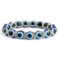 Blauwe boze oog stretch kristal kralen armband met glinsterende strass tussenringen. - Gouden Rand Strass / Wit