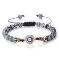 Bracelet de perles œil turc avec des strass brillants et un cordon tressé noir réglable. - Pierre de Paon Grise