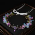 Exquisite floral crown with blue butterflies, purple crystal moon pendant, and white ribbon. - Pink Purple Floral Wreath