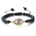 Bracelet de perles en pierre noire œil maléfique avec breloque strass dorée et cordon réglable. - Pierre Noire Veine Blanche Or
