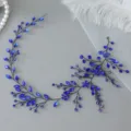 Close-up detail shot of the blue crystal rhinestone hair vine, featuring delicate wire braided design. - Black Blue