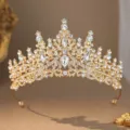 Close up detail of sparkling gold tiara with clear rhinestones, bridal hair accessory. - Gold White