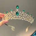 Detailed view of gold bridal tiara with green rhinestones and hair combs for wedding accessory. - Gold with Green Zirconia