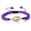 Bracelet de perles violettes avec un pendentif œil maléfique doré en strass et cordon réglable. - Pierre Violette (Mauvais Oeil Doré)