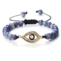 Bracelet de perles bleues avec pendentif œil grec doré et cordon noir réglable. - Pierre à Point Bleu Or