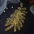 Detailed close-up of gold rhinestone bridal hair piece, handcrafted leaf design accessory. - Golden Yellow