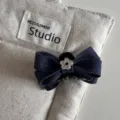 Denim blue hair claw clip featuring a cute bow and silver flower accent. Detail view. - Mini Hair Claw / Denim Blue
