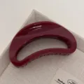 Burgundy crescent hair claw clip close-up shot, elegant resin shark clip for styling. - Crescent Moon / Gold Glitter Red