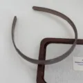 Detailed view of a translucent brown plastic hairband with teeth for daily washing face and styling. - Coffee