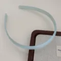 Detail view of light blue plastic hair hoop with teeth, translucent jelly style for daily wear. - Light Green