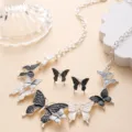 Detailed view of black and white enamel butterfly alloy necklace and matching earrings set. - Black and White Butterfly Set (J8-1)