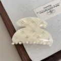 Exquisite white acetate hair claw clip featuring delicate rhinestone star accents for elegant daily use. - Yellow White