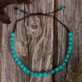 Detailed shot of handmade turquoise beaded necklace and bracelet with brown cord. - Turquoise Textured Cylinder Bead Style (C23 -574)