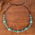 Bohemian turquoise beaded necklace detail showcasing retro metal spacers and adjustable cord. - Turquoise Bead with Antique Metal Accent Style (C23-578)