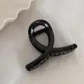 Gros plan détaillé d'une pince à cheveux noire élégante avec des pois rouges mignons. - Pince de Type Croix / Noir
