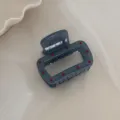 Close-up detail of the grey-blue polka dot hair claw clip, showing its unique texture. - Small Square Claw Clip / Fog Blue