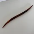Detail view of a stylish tortoiseshell acetate hair stick, elegant curved hairpin for chic buns. - Iridescent Deep Coffee