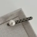 Close-up of the elegant polka dot pearl hair clip detail, showcasing the stylish design. - Straight Artificial Pearl Hair Clip / Premium Grey